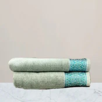 a stack of towels on a marble surface green towel 600 gsm towel